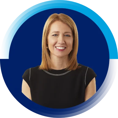 Susan Street Whaley, Chief Legal Officer and Secretary, is smiling towards the camera. Che has short blond hair and is wearing a black top.