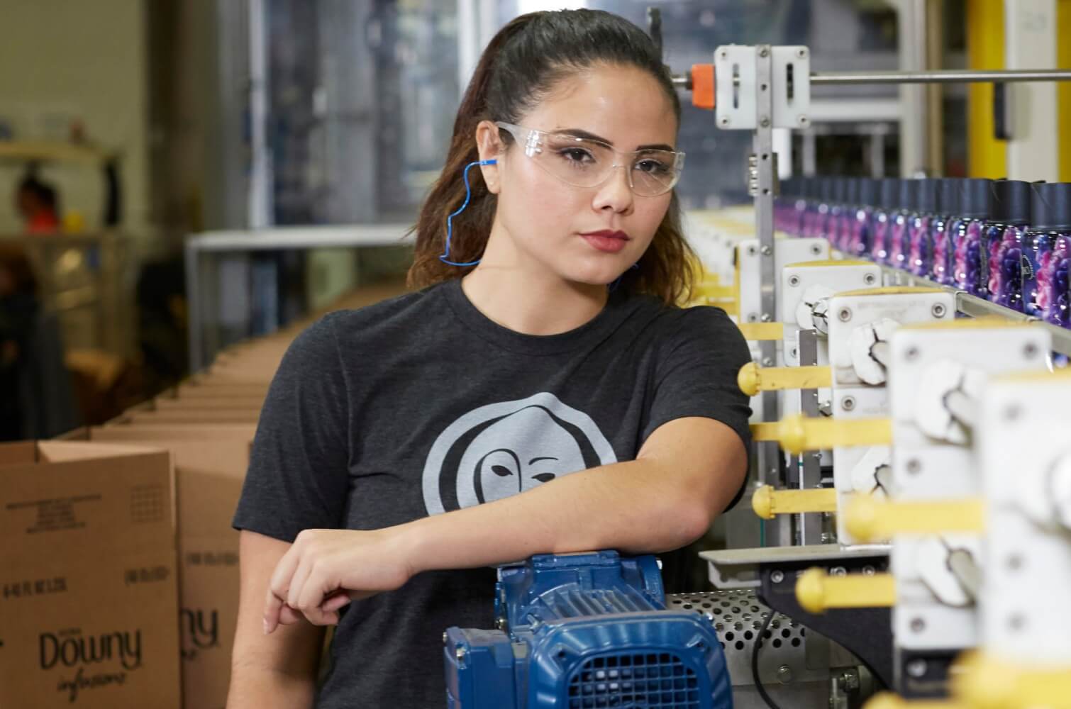 Female P&G plant employee oversees production line of Downy fabric softener