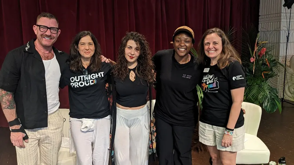 Participants of Girls Just Wanna Weekend’s “Rooted in Resilience” panel stand together smiling.