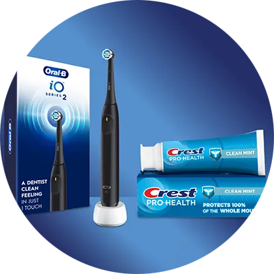 A black electric toothbrush and its packaging are displayed alongside a tube and box of clean mint toothpaste, all against a blue background.