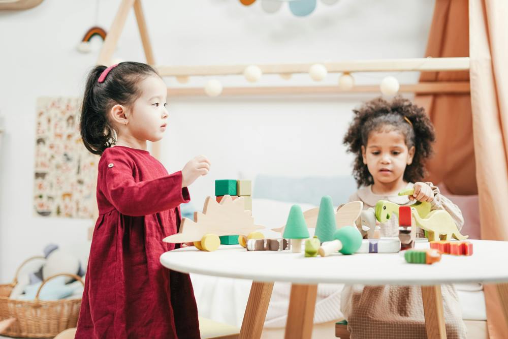 Two little girls playing with toys