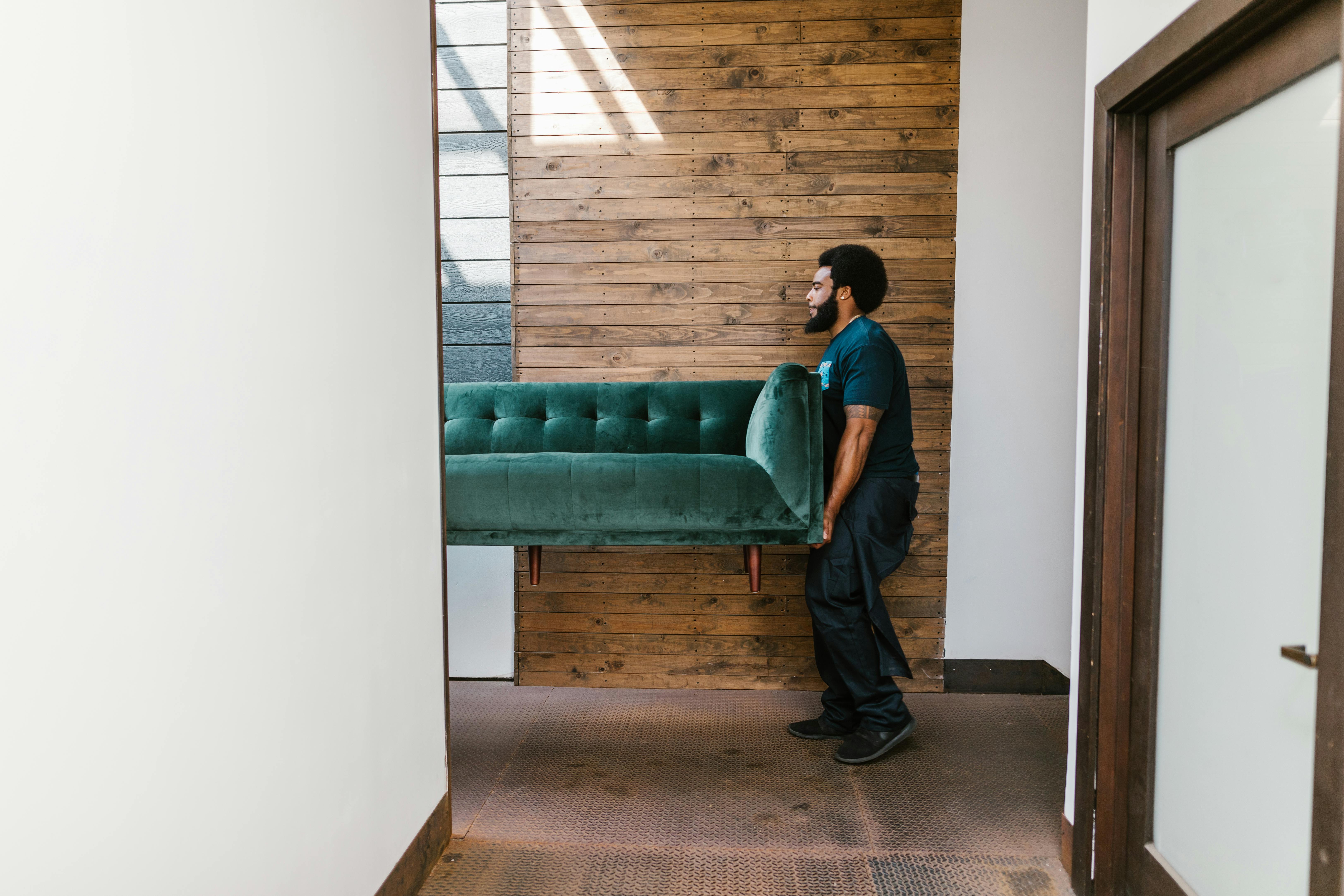 https://www.pexels.com/photo/man-in-blue-denim-jeans-sitting-on-green-sofa-7464722/