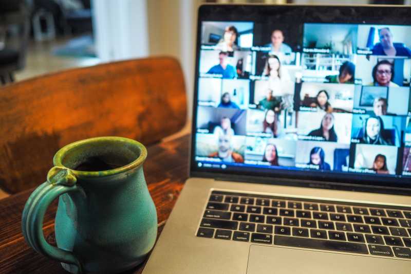 A coffee cup next to an open laptop