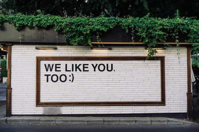 The message “we like you too” written on a wall