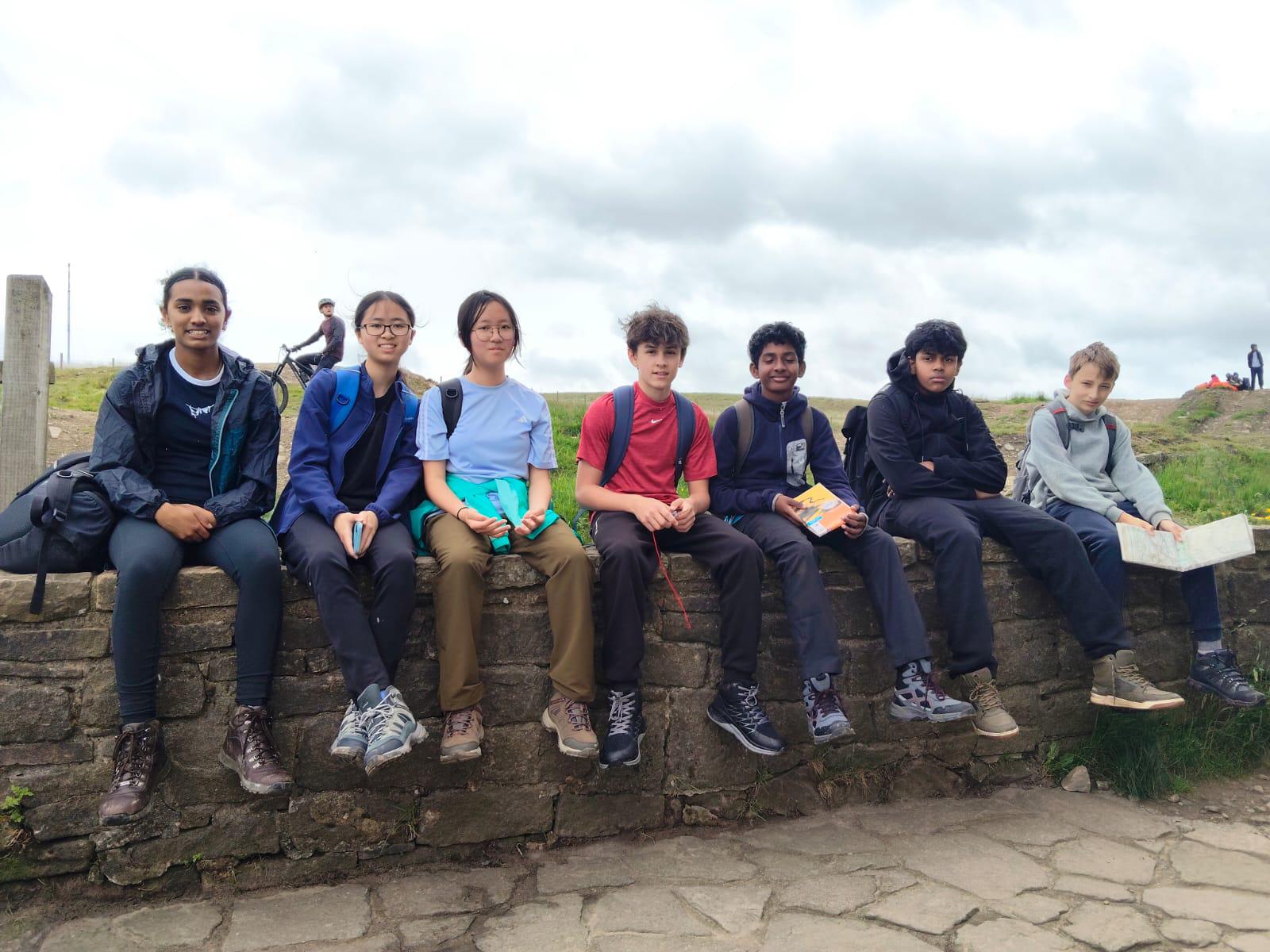Group sitting on wall