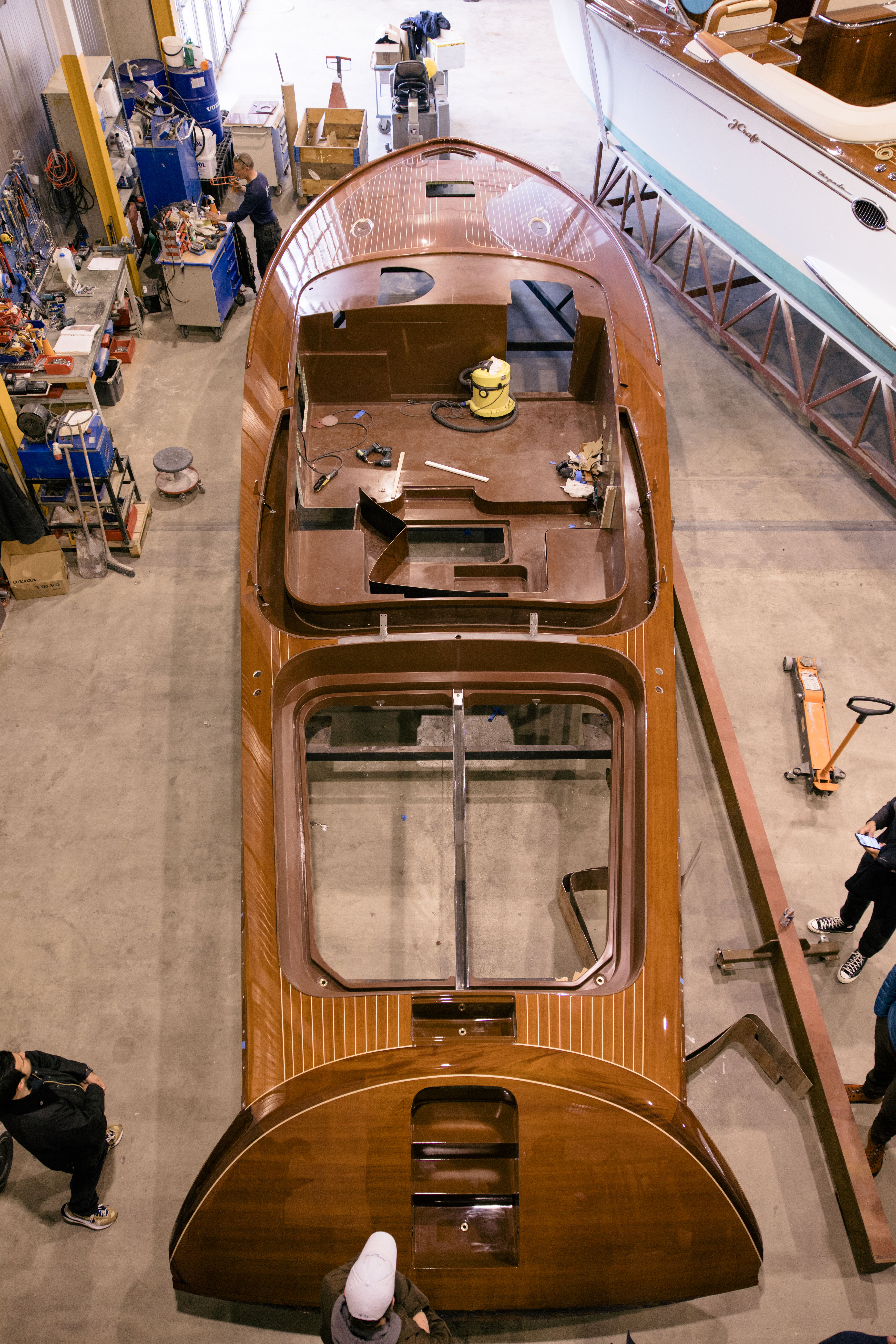 Overhead view inside J Craft factory with a Torpedo mid-build, mahogany deck taking shape