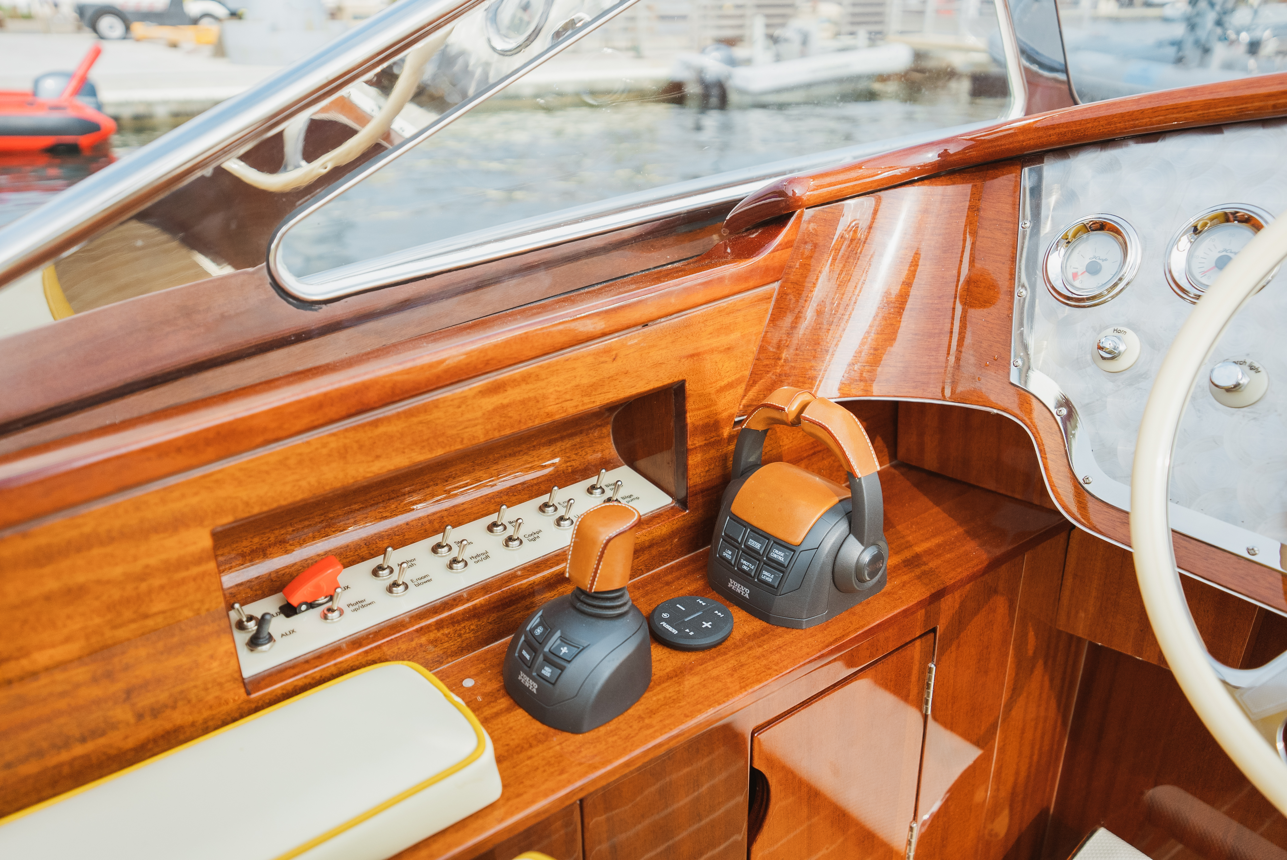 J Craft Torpedo helm station with polished mahogany dash, Volvo Penta controls, and chrome gauges