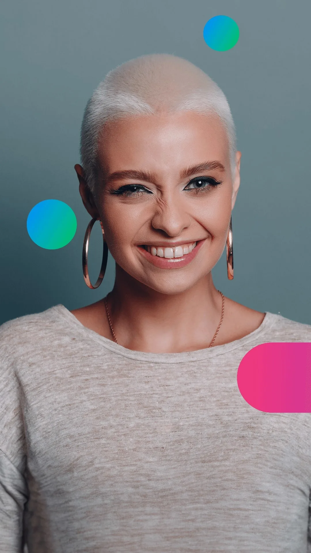 A woman with short blonde hair, wearing large hoop earrings, smiles broadly.