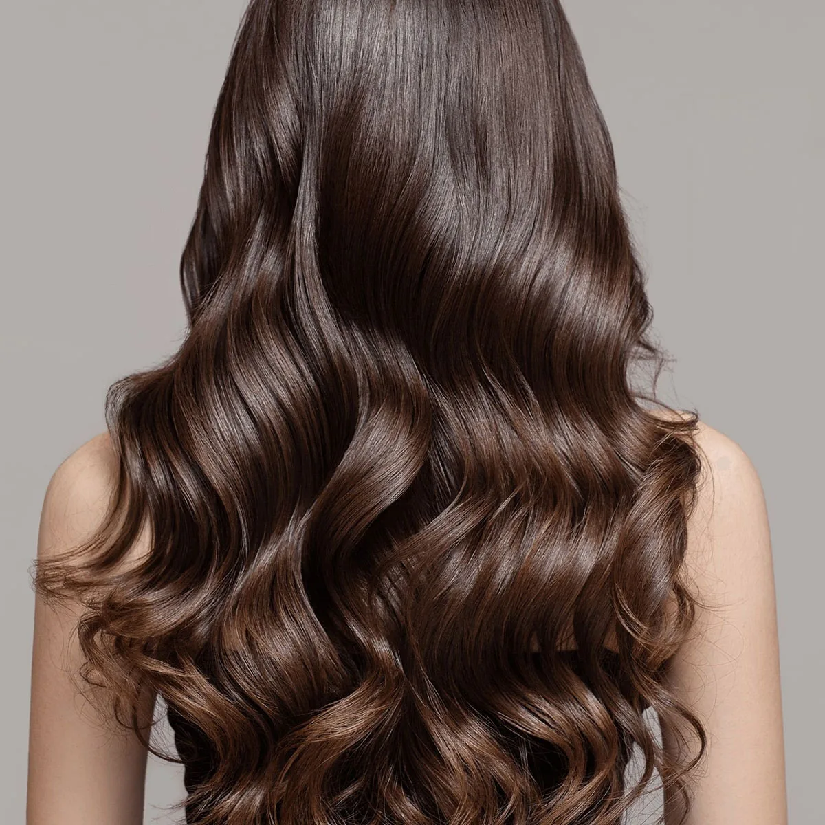 Long, wavy brown hair flowing down a woman's back.