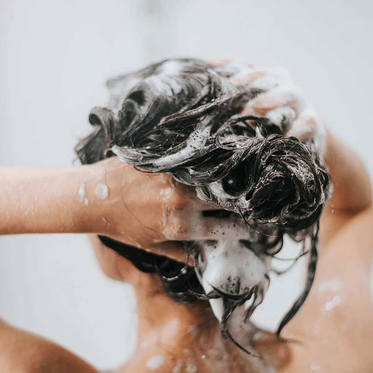 A photo of a woman washing her hair