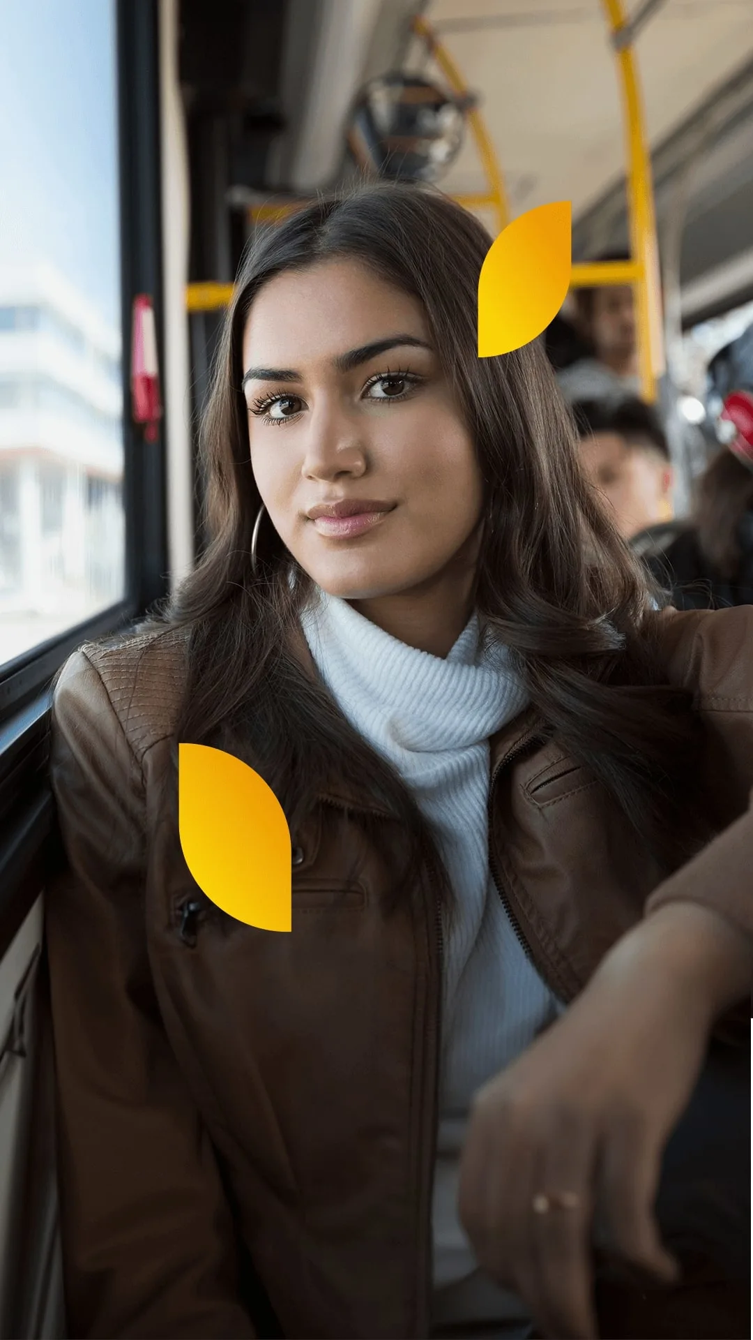 Portrait of a woman with dark hair sitting in public transportation.