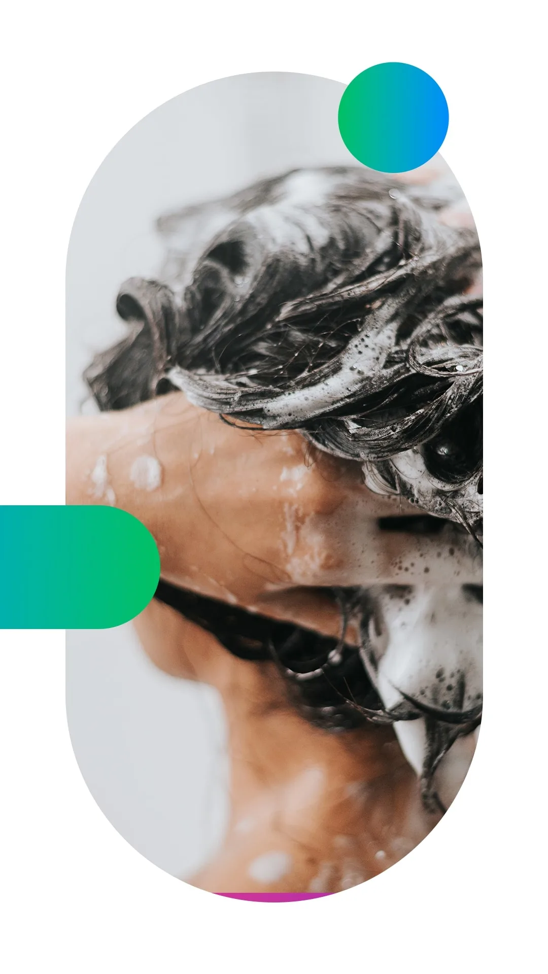 A close up photo of a hand during hair washing, the foam between the dark hair