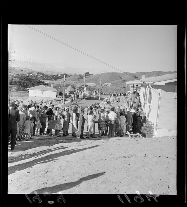 Outdoor photo of crowd gathering in a queue