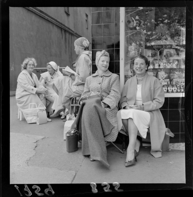 5 Women queuing outside a store in a vintage photo