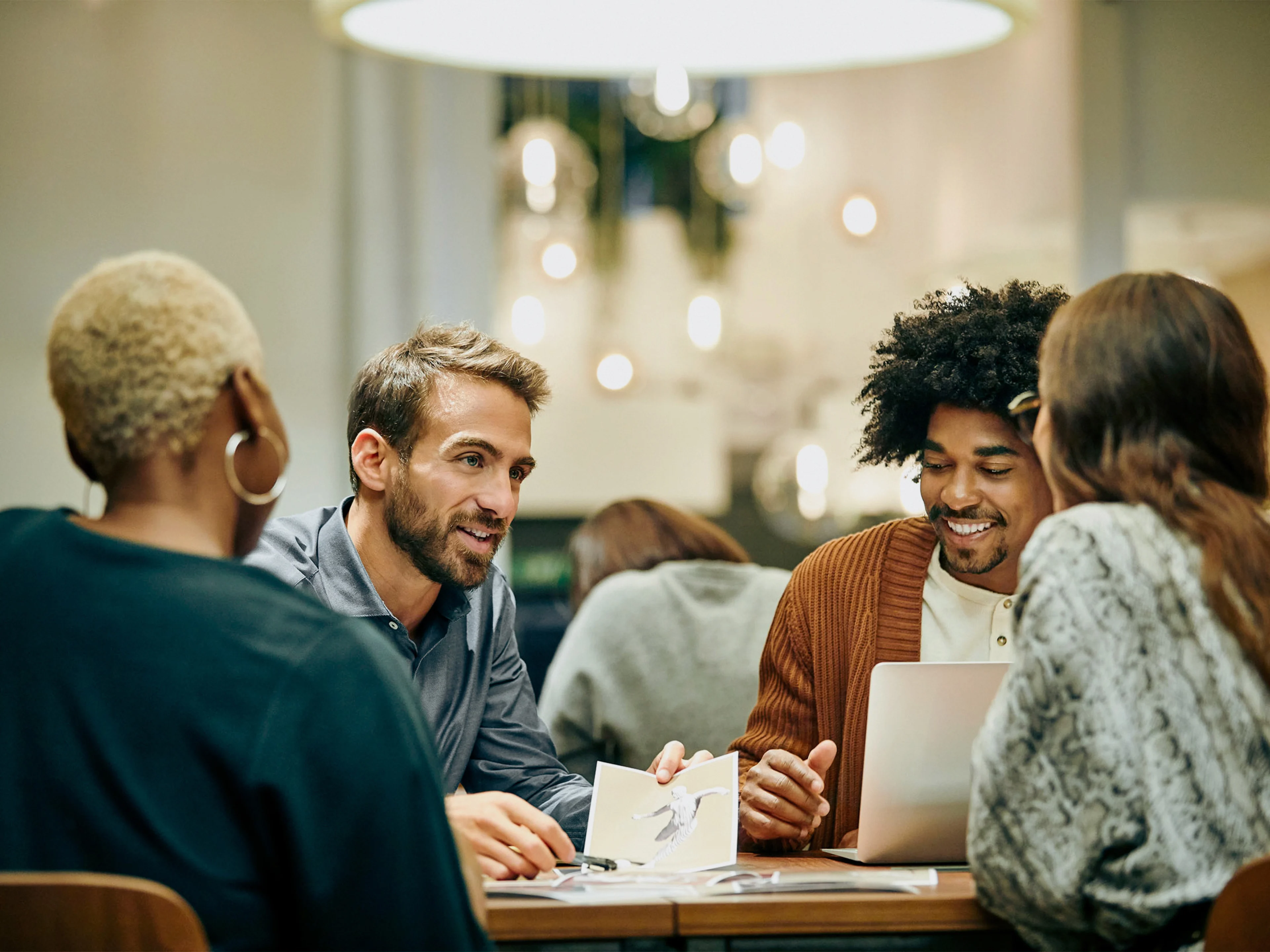 Multi-ethnic coworkers discussing in office.