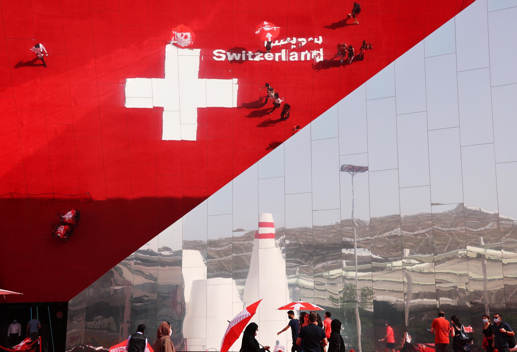 Visitors are reflected on the Switzerland Pavilion Web Image m41593
