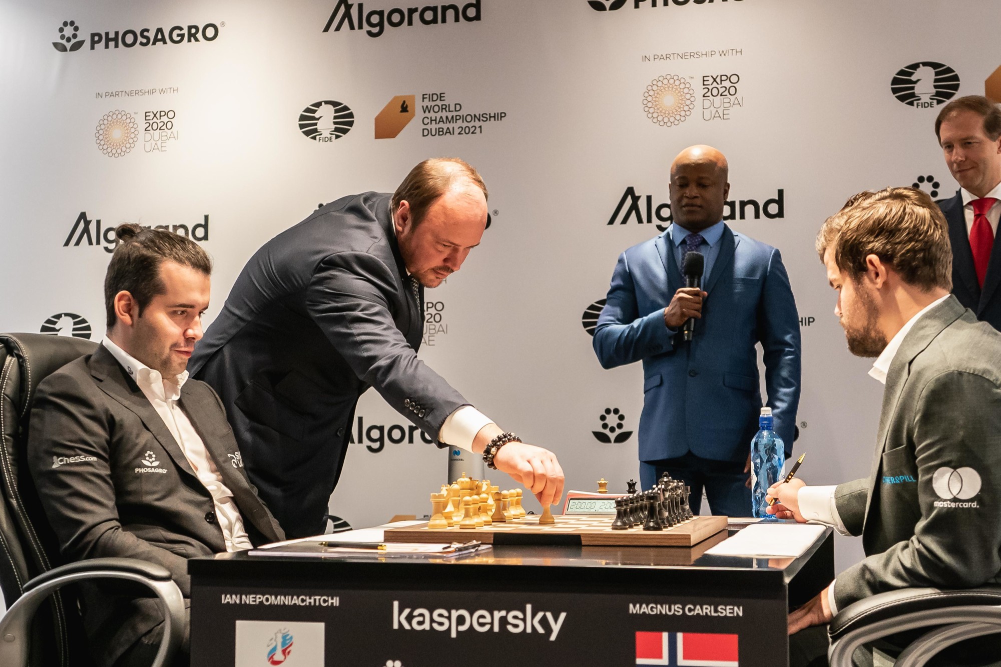 FIDE World Chess Championship first chess piece move is made by Andrey Guryev (L2) CEO of Phosagro accompanied on the stage by Denis Manturov (R1) Minister of Industry and Trade of the Russian Federation for World Chess Championship Game