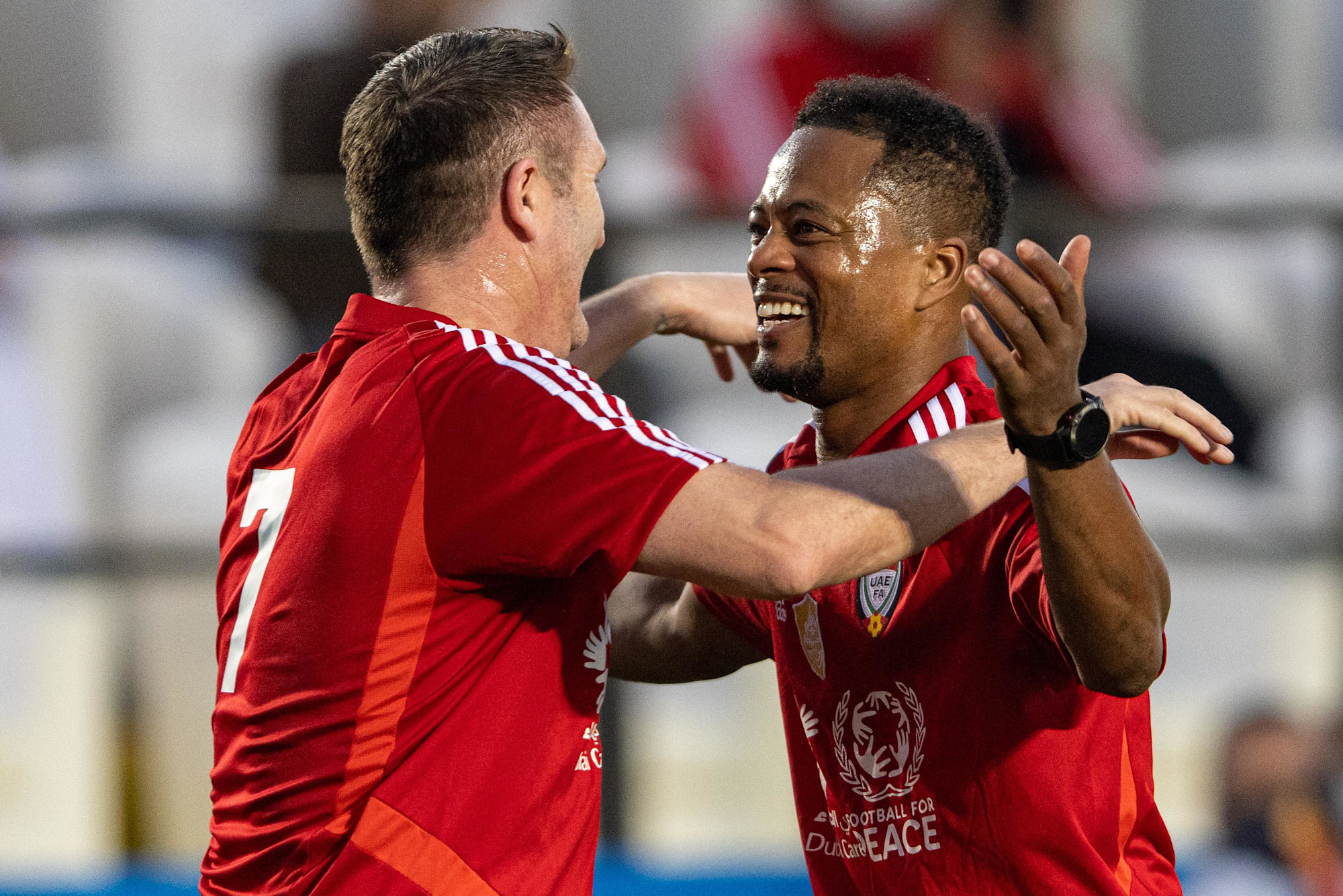 Patrice Evra (R) and Robbie Keane of Team Patman celebrate a goal during the UAE All Stars Football tournament at the Expo Sports Arena m30761