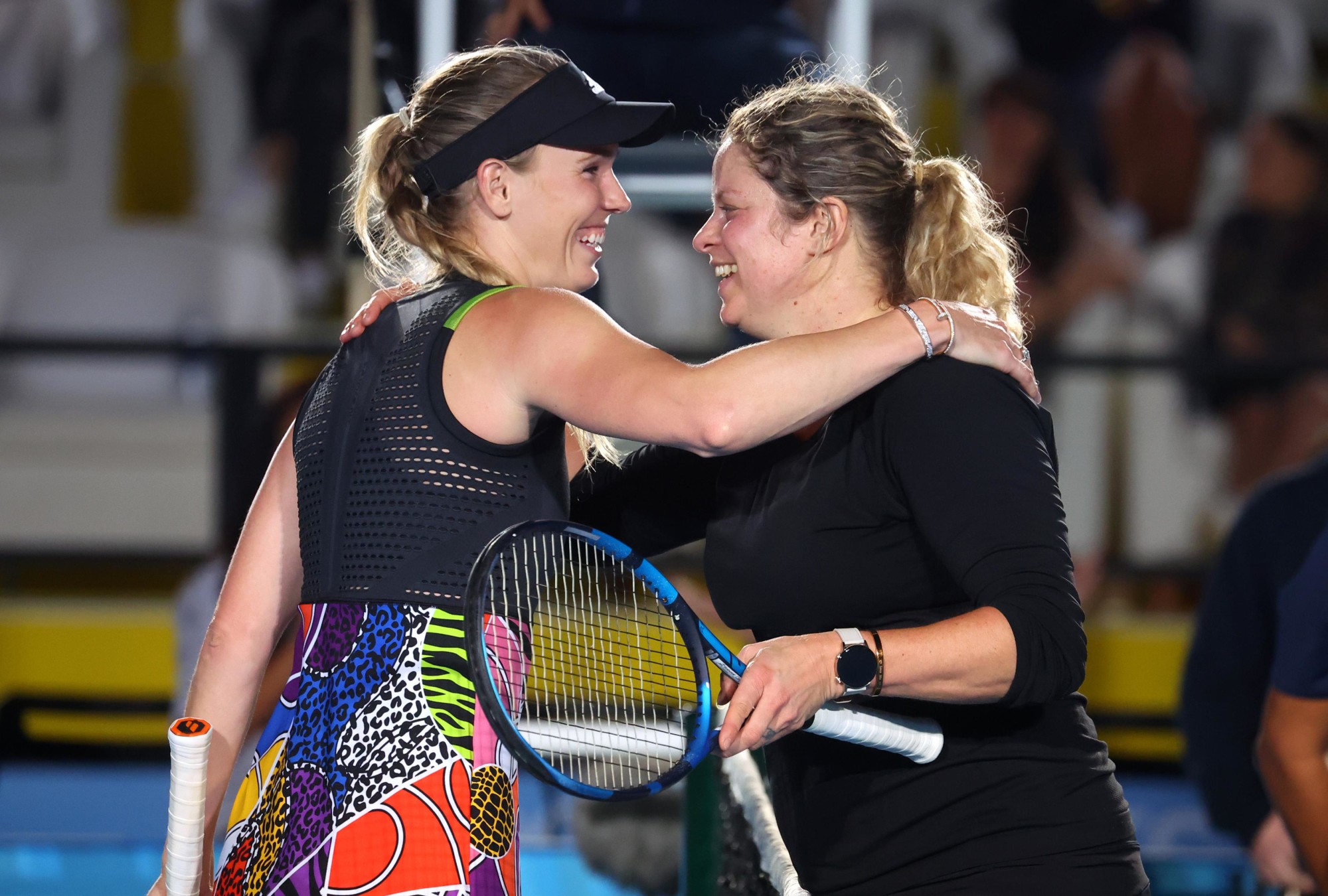 Tennis legends Caroline Wozniacki (L) and Kim Clijsters embrace during the Women’s Singles Exhibition Game for Expo 2020 Dubai Tennis Week at the Expo Sports Aren m52489