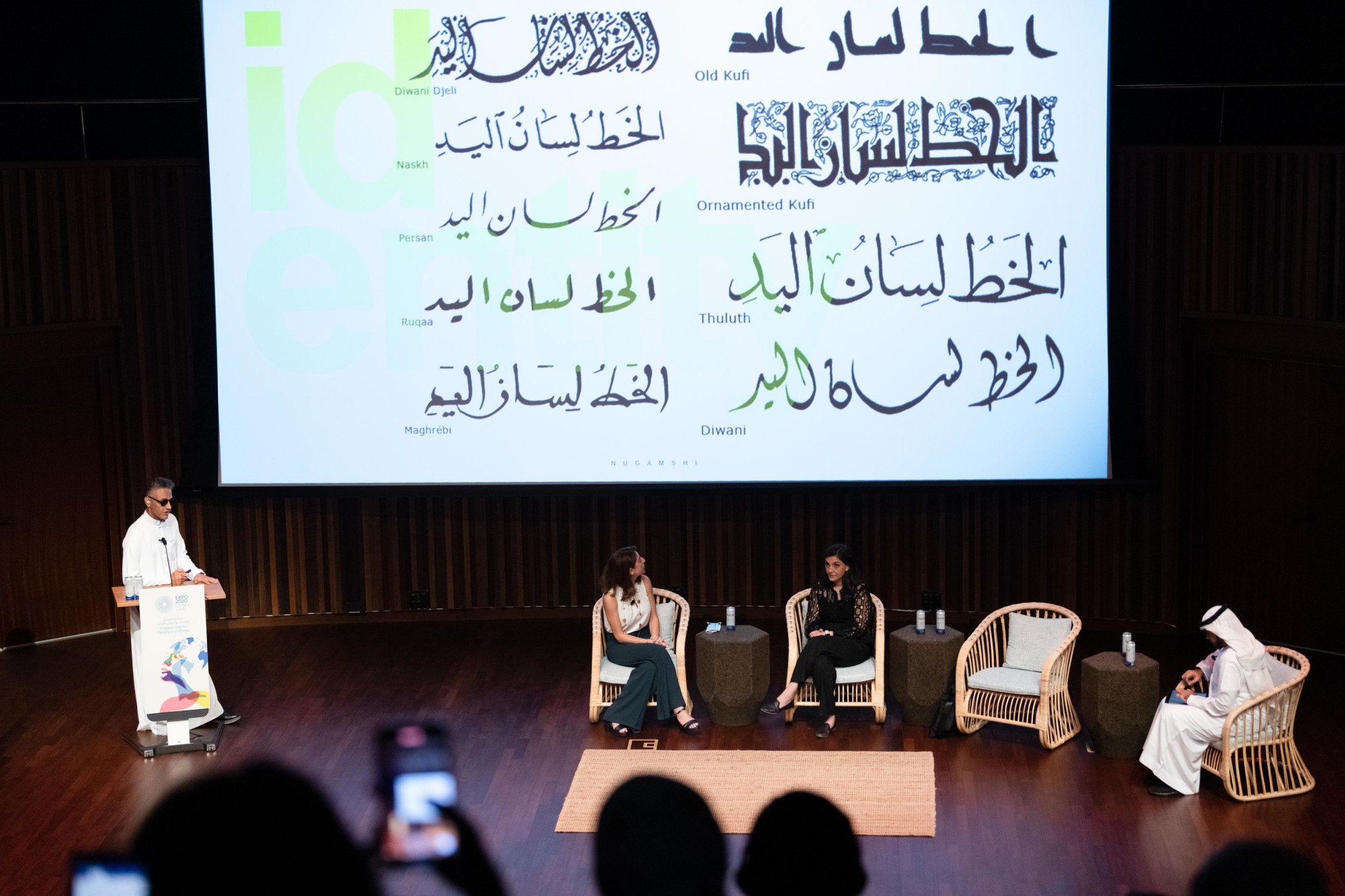 Calligraphy artist Nugamashi (L) speaks at the World Arabic Language Day Flagship event at Terra Auditorium m24538