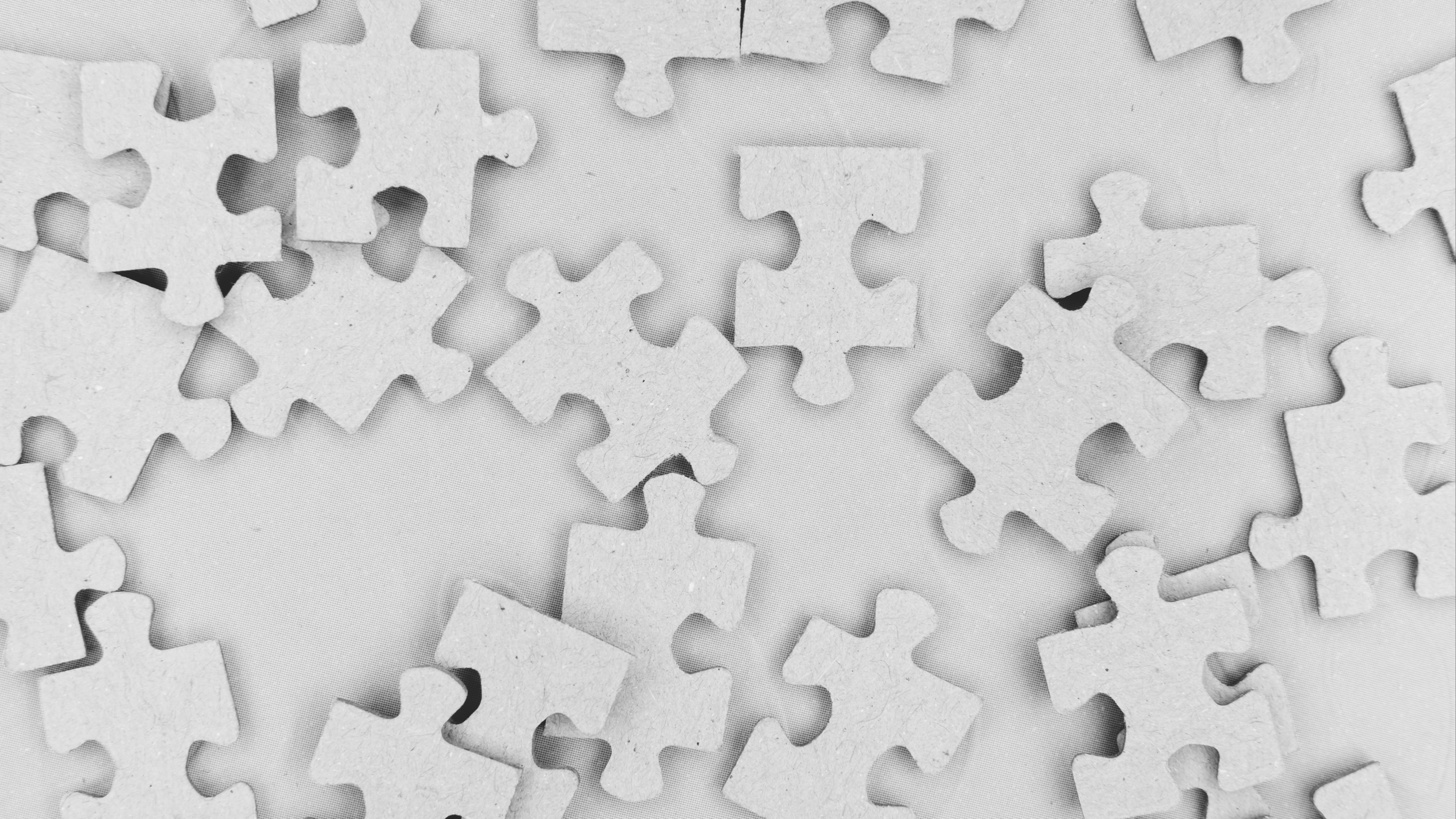 Blank puzzle pieces in a pile.