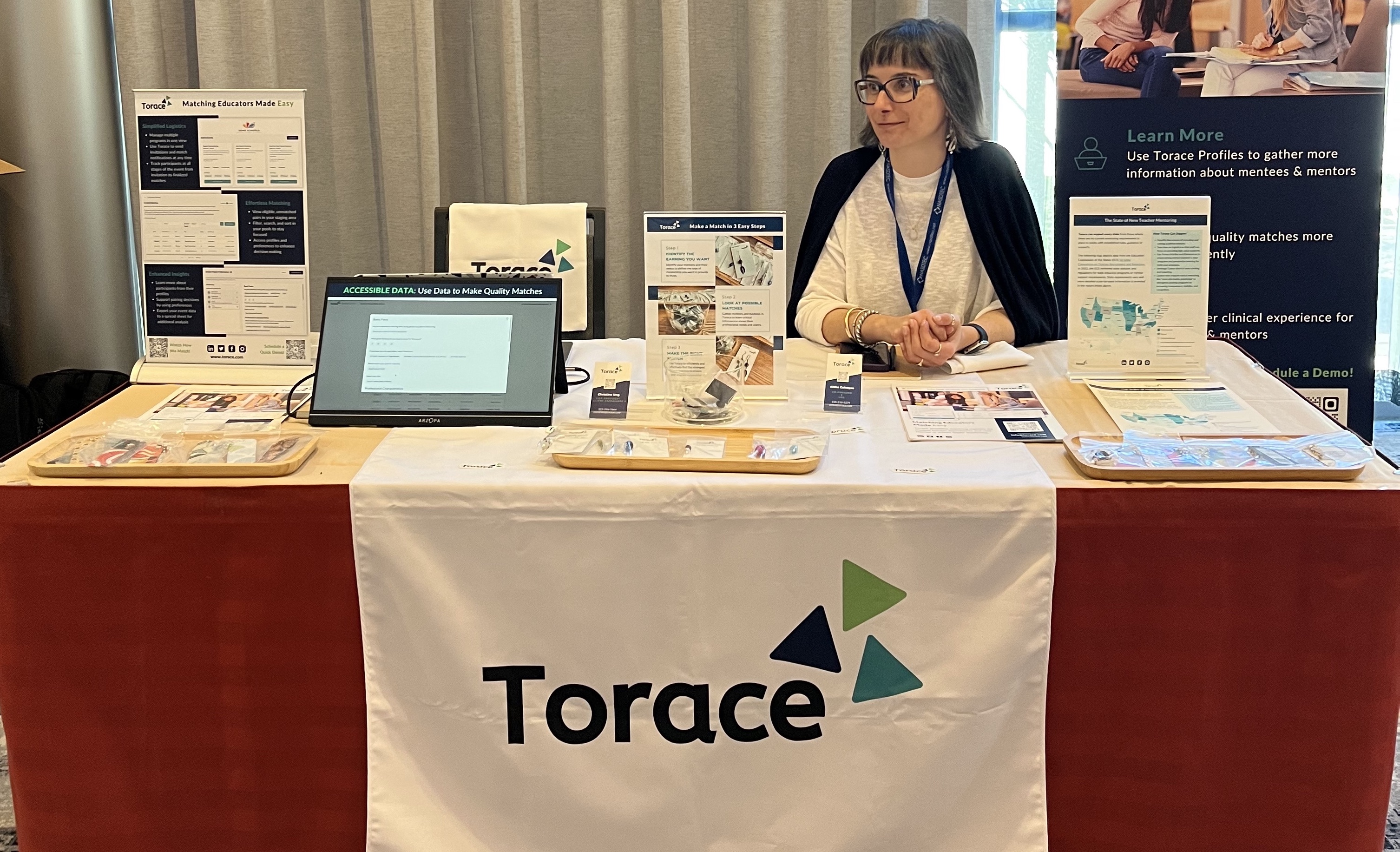 Aleka, CEO & Co-founder, sitting at the Torace table at the 2023 NASDTEC Conference in Phoenix, Arizona.