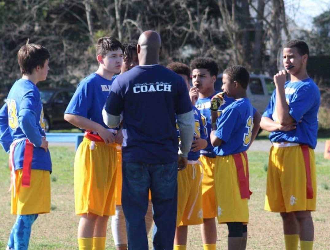 Dominic Banks coaching a football team.