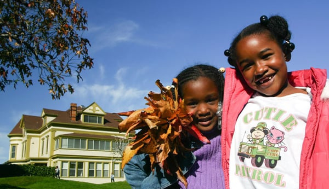 Two students at St. Vincent Day Home standing in front of the historical building.