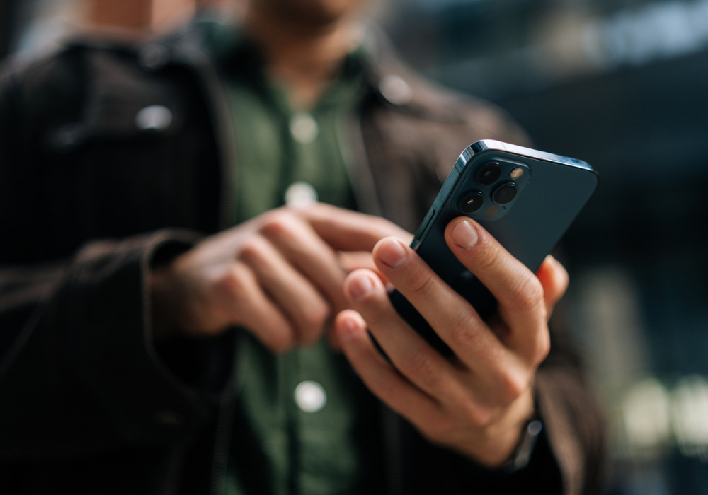 Cropped image of a man using smartphone device