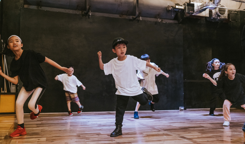 Kids dancing in a gym.
