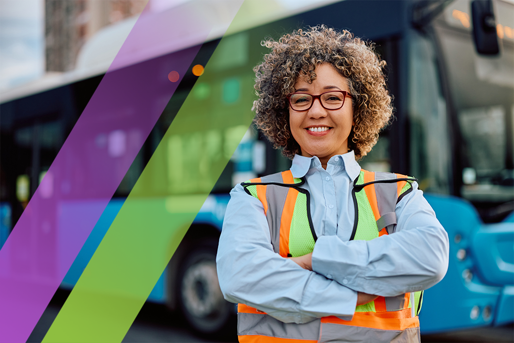 A bus driver standing in front of a bus