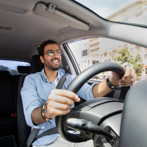 Man smiling driving car