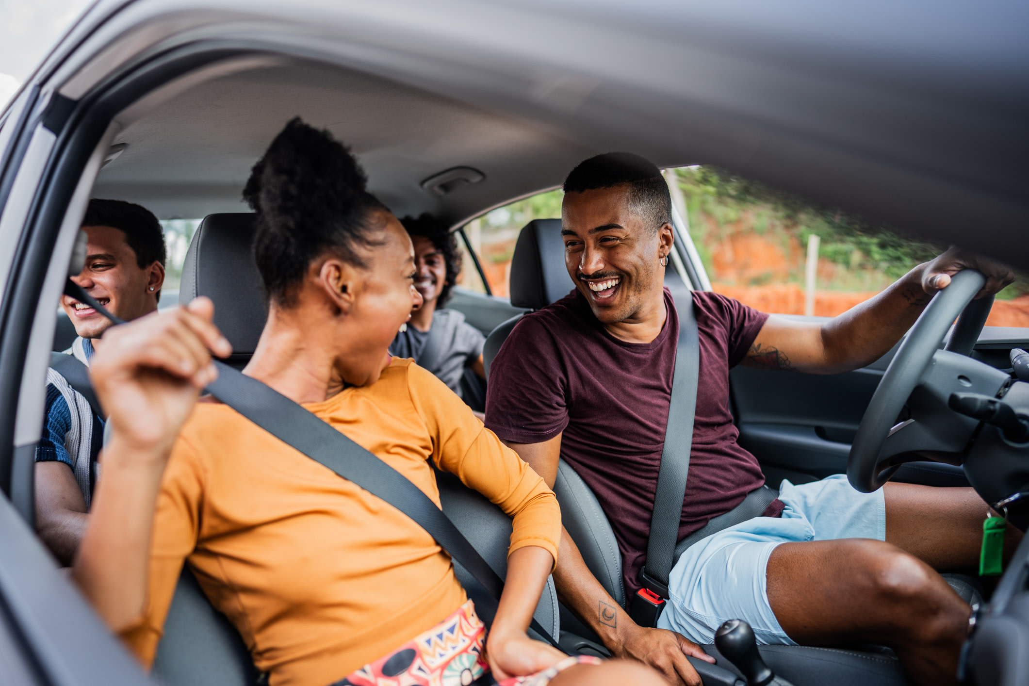 Four people having fun in a car.