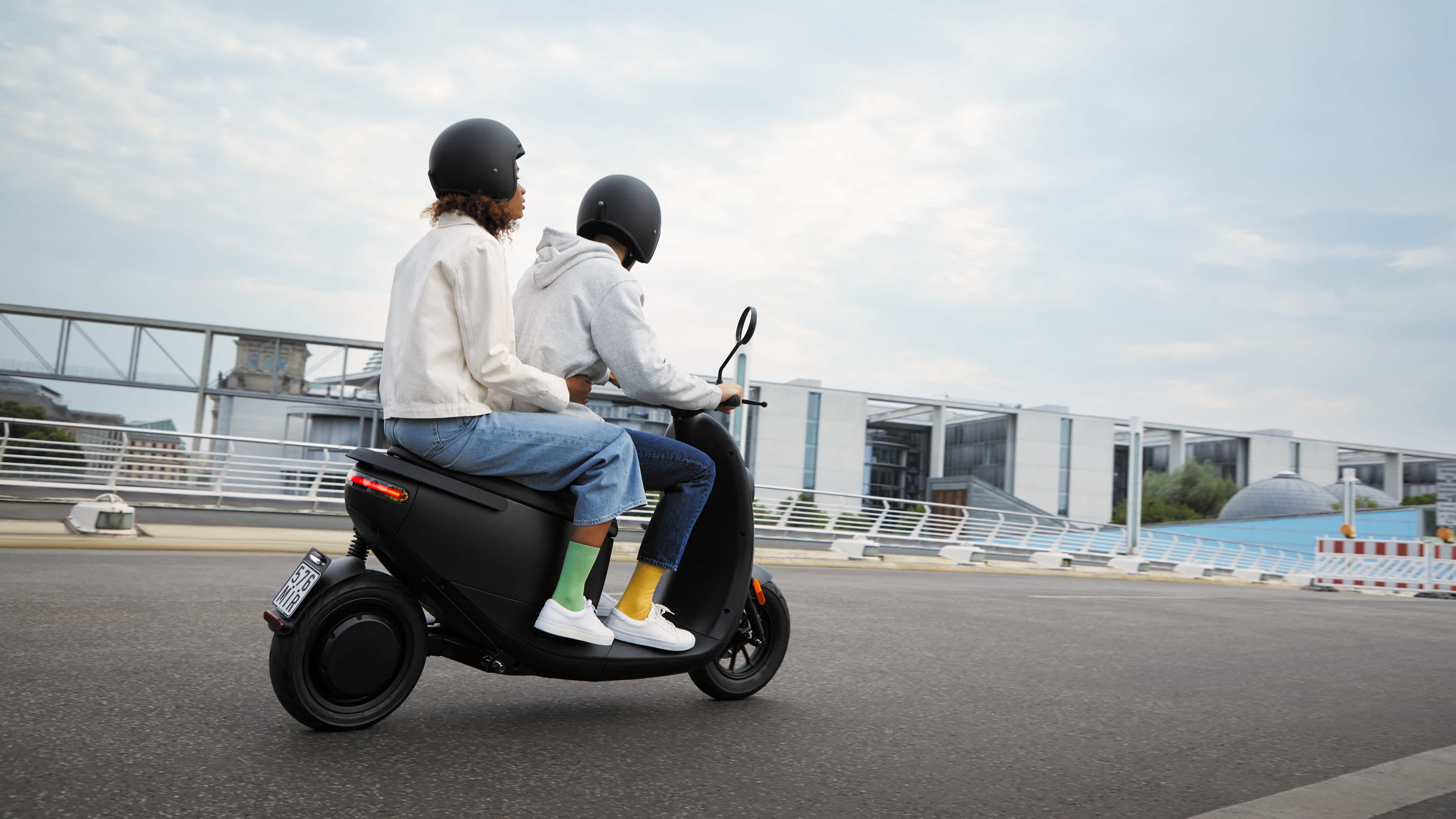 Two people on unu scooter