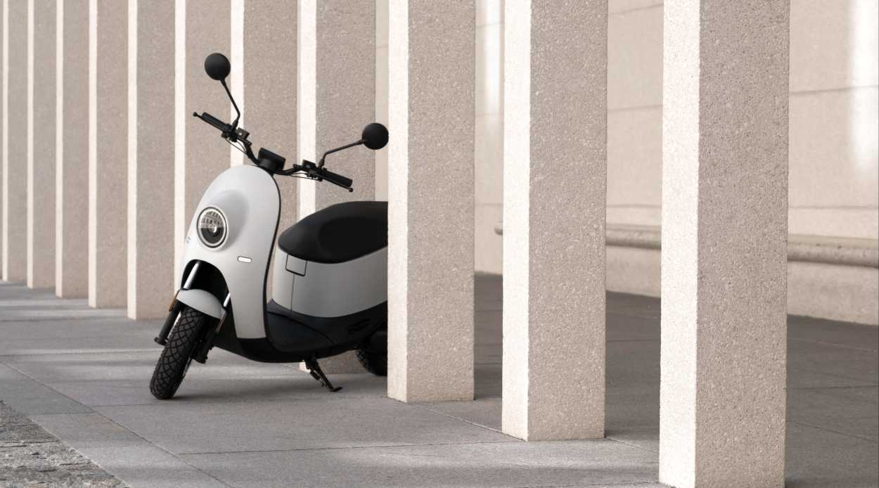 White scooter between columns