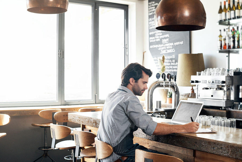 GettyImages-879769472-Man small business owner cafe with laptop-1200px-1024x684