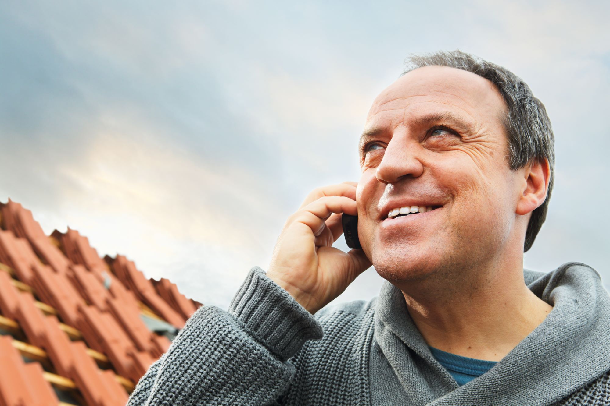 Roofer on-site calling BMI Redland Technical Services