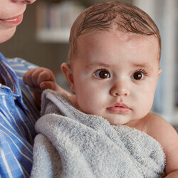 Baby in towel after bath