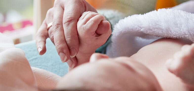 baby towel holding mother hand