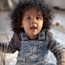 baby holding whisk