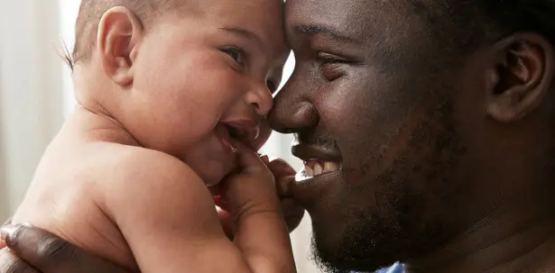 Johnson's Baby father and baby smiling together image