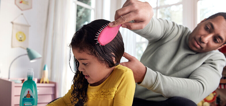 dad brushing daughter hair