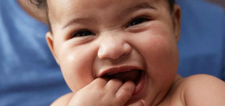 Laughing baby with curly hair