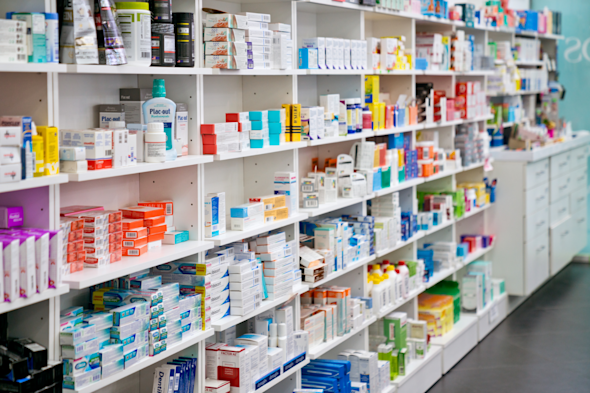 An image of shelves in a pharmacy, showing various medications.