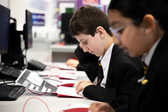Students following instructions during a computing lesson