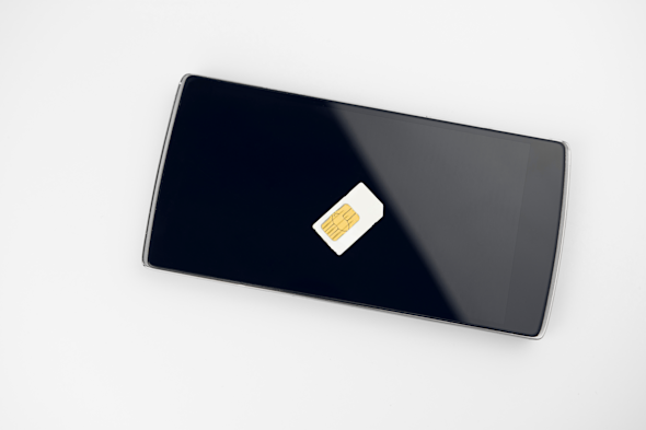 A smartphone, with a sim card on top.