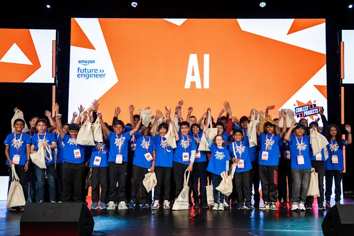 Young people on stage at Coolest Projects UK celebrate their AI projects.