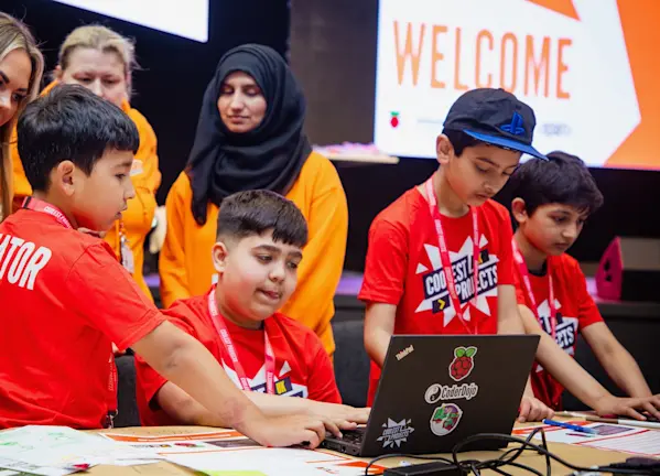 Young people work on their tech creations at a Coolest Projects event.