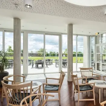 The dining hall at the Møller Institute, with views to outside grounds.