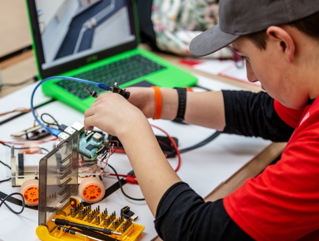 A young person with a robotics project.